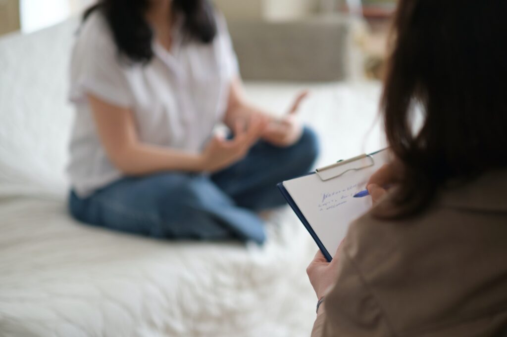 patient makes progress towards healing and recovery as she talks with her therapist about her