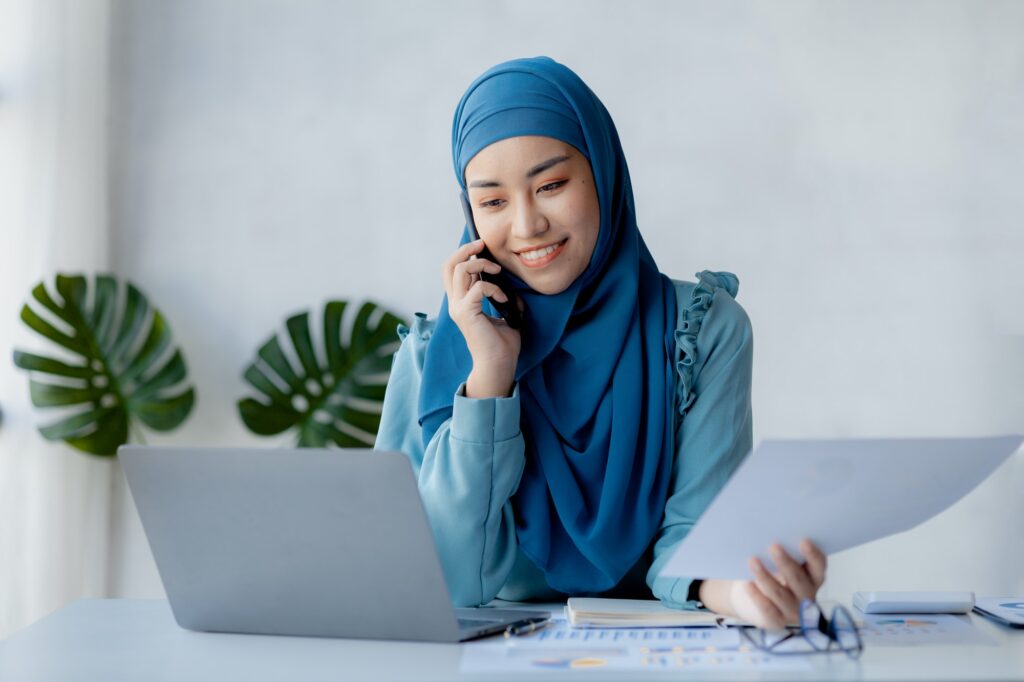 Asian women in hijab are talking on the phone, administration and operations from the new generation